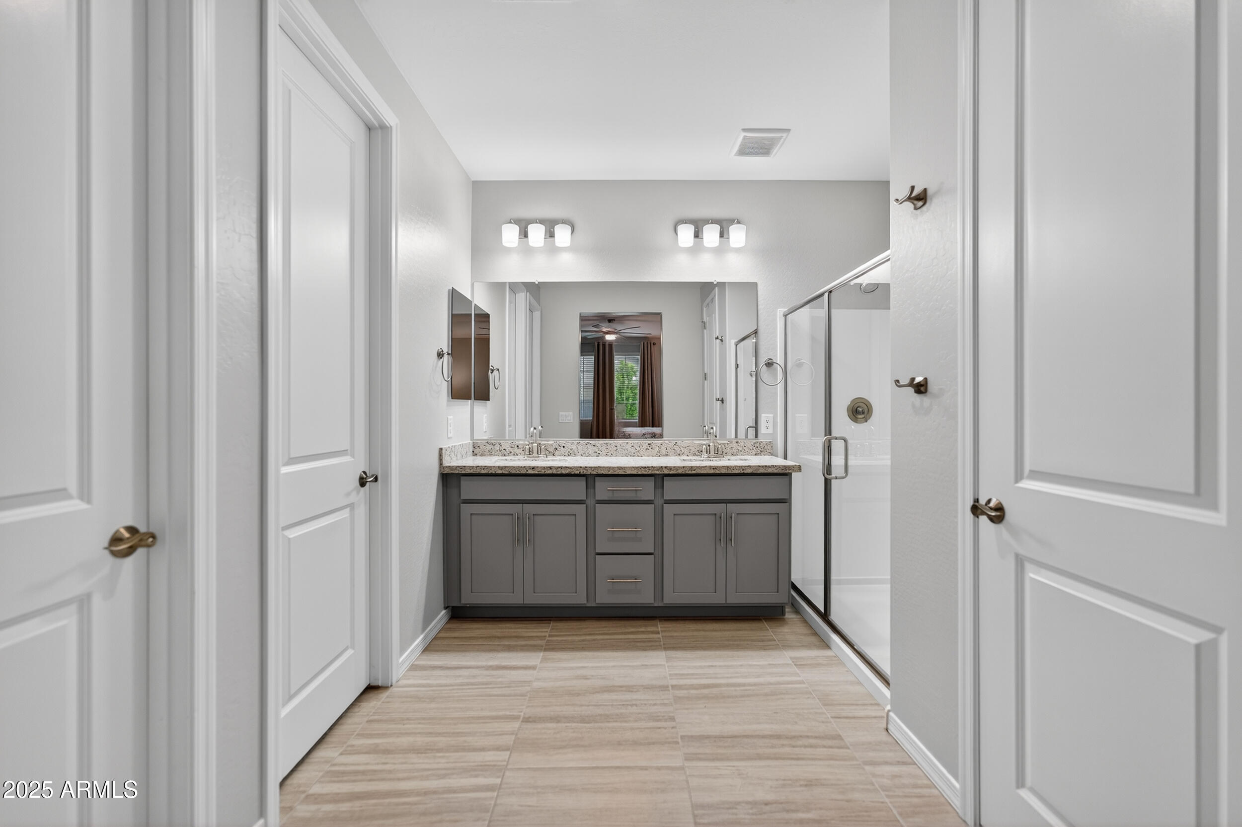 10218 West Piccadilly Road Avondale, AZ 85392 - Photo 17 of 28 a large white bathroom with a granite countertop sink mirror and a bathtub