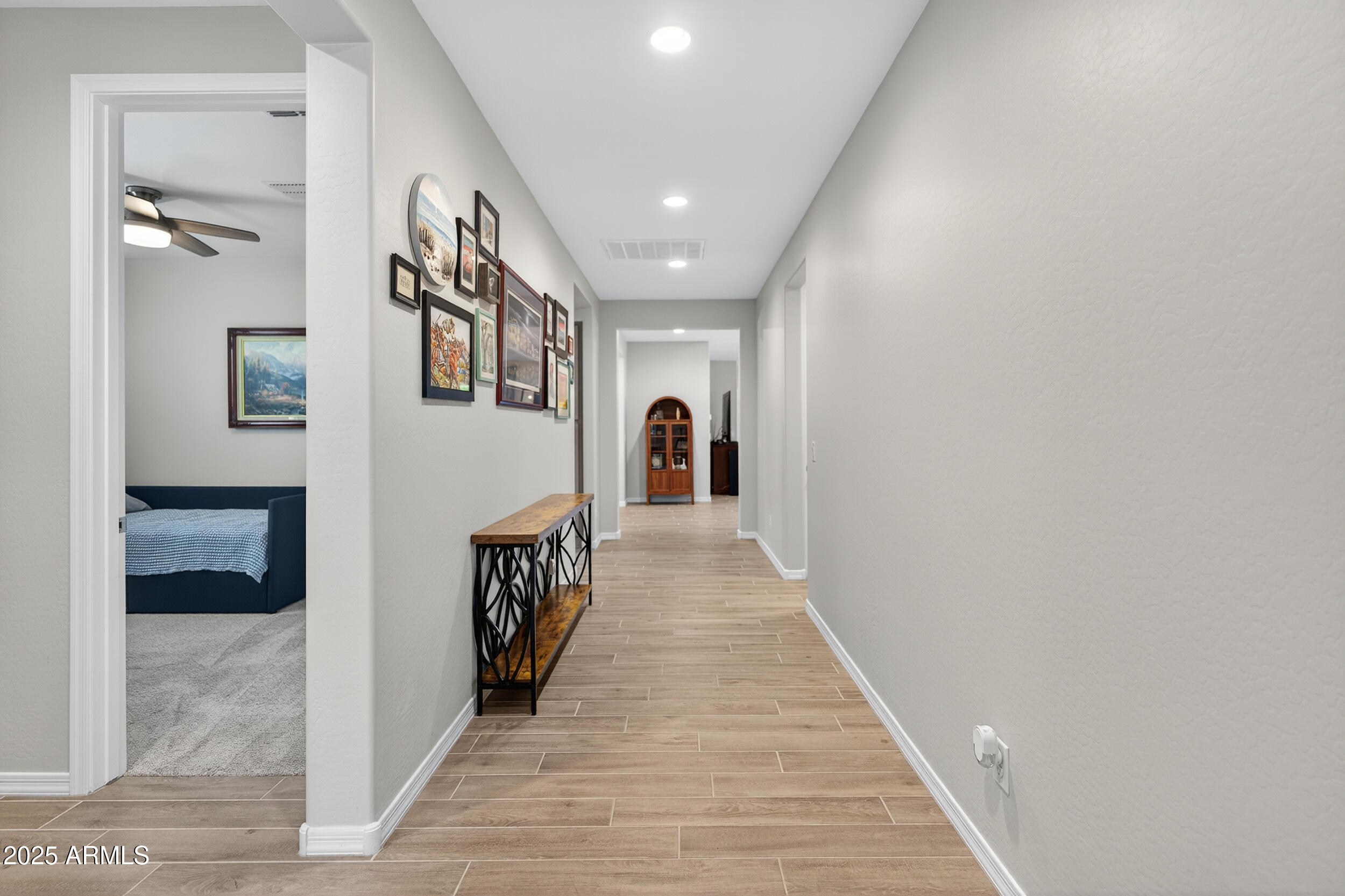 10218 West Piccadilly Road Avondale, AZ 85392 - Photo 22 of 28 a hallway with wooden floor and stairs