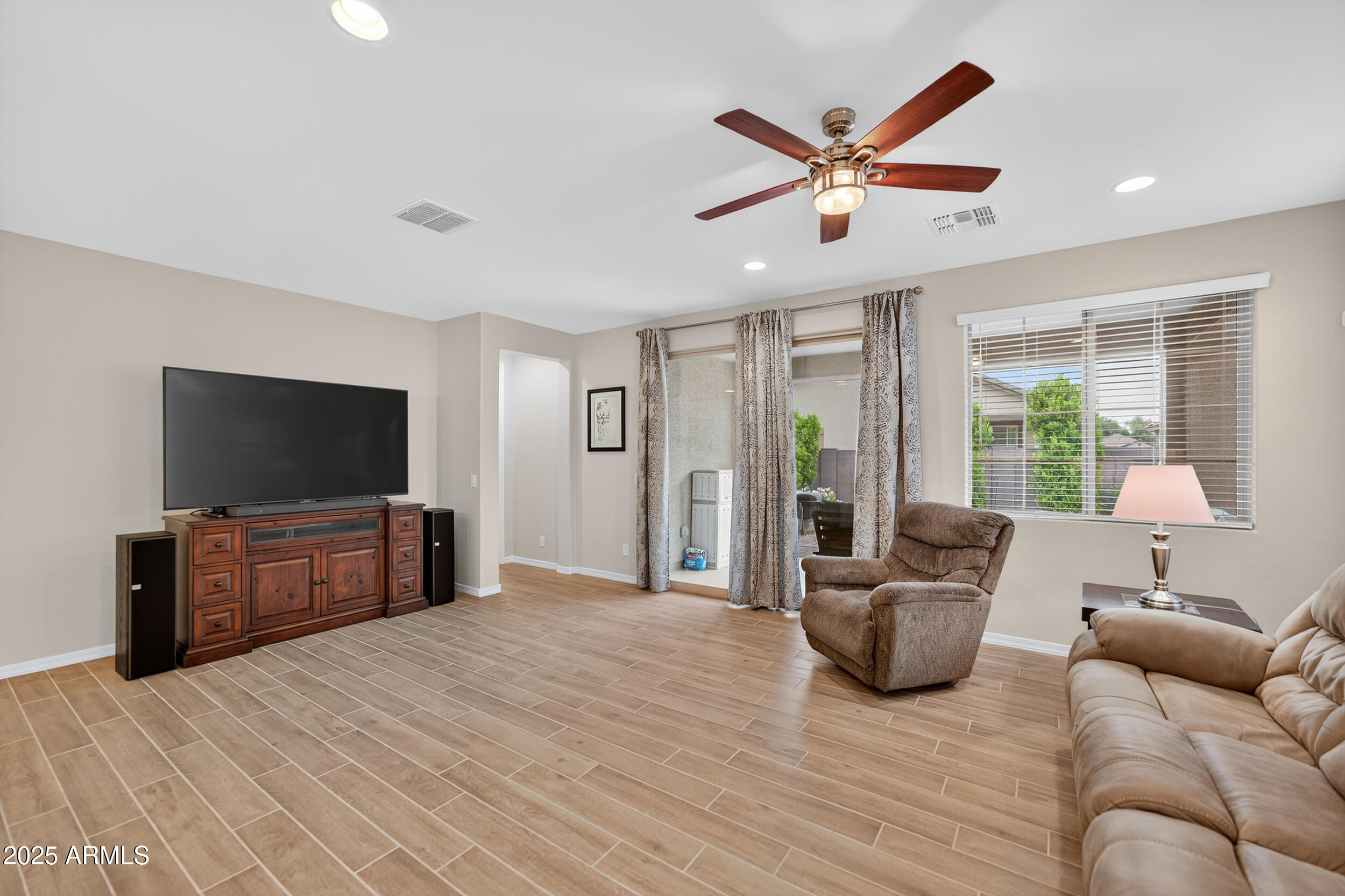 10218 West Piccadilly Road Avondale, AZ 85392 - Photo 9 of 28 a living room with furniture and a flat screen tv