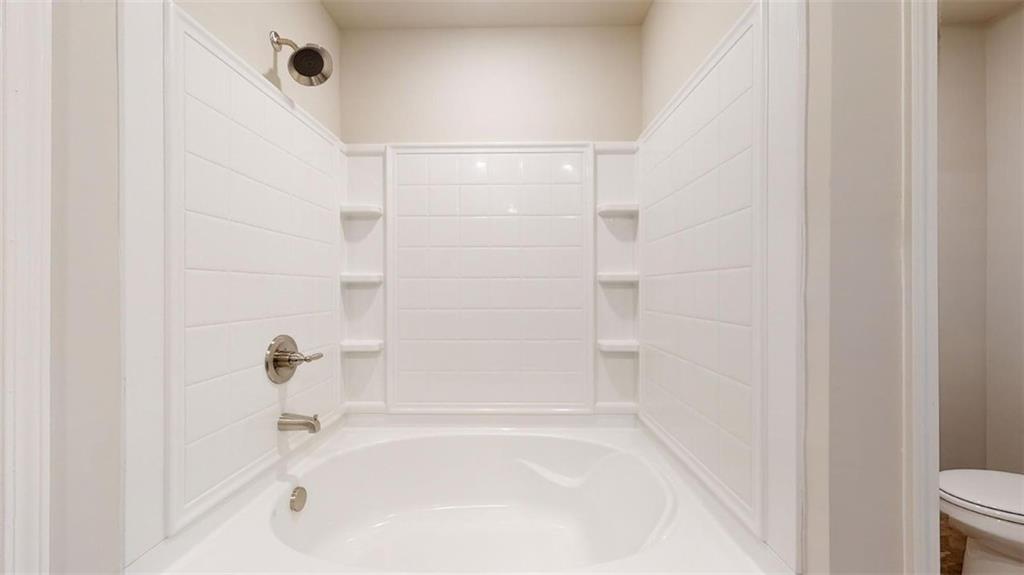 145 Weldon Road McDonough, GA 30253 - Photo 22 of 32 a bathroom with a bathtub