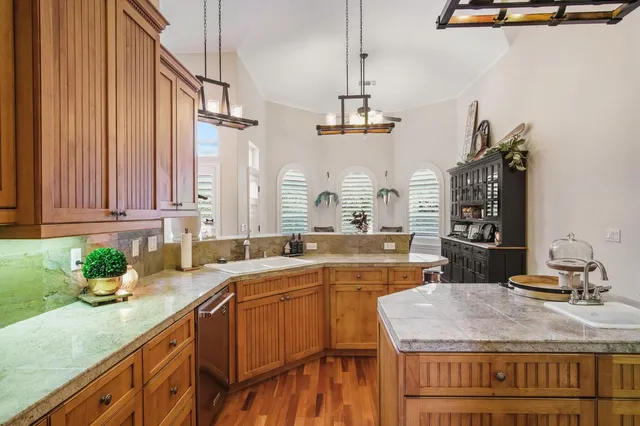 a kitchen with a sink stove and cabinets