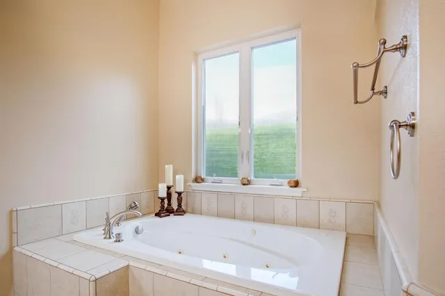a bathroom with a tub sink and window