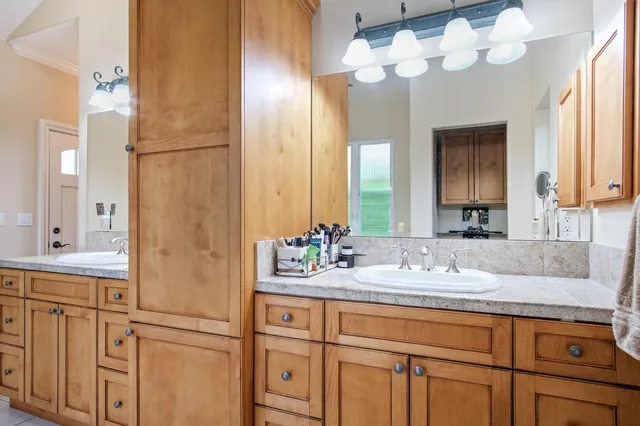 a bathroom with a sink vanity and a mirror