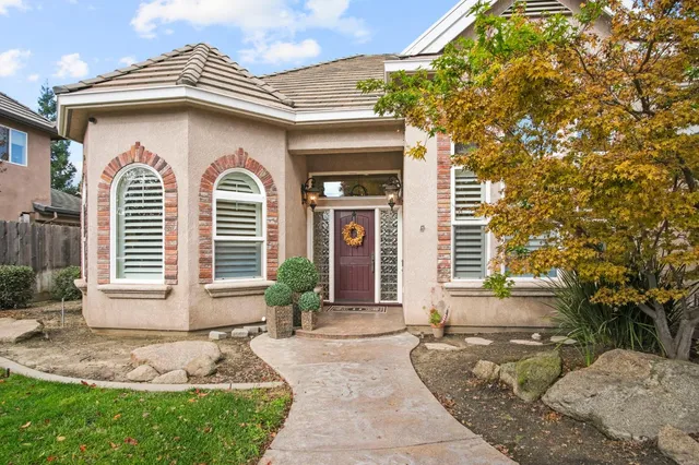 a front view of a house with garden