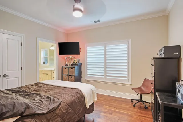 a bedroom with a bed and a chair