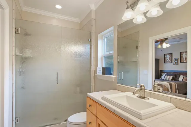 a bathroom with a sink vanity mirror and toilet