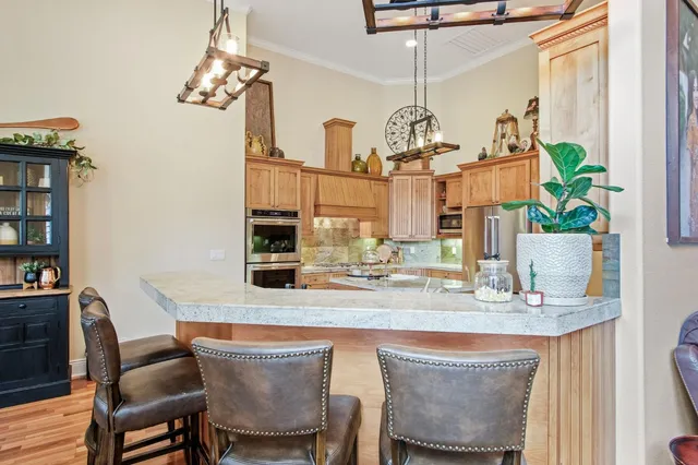 a dining room with furniture a chandelier and window
