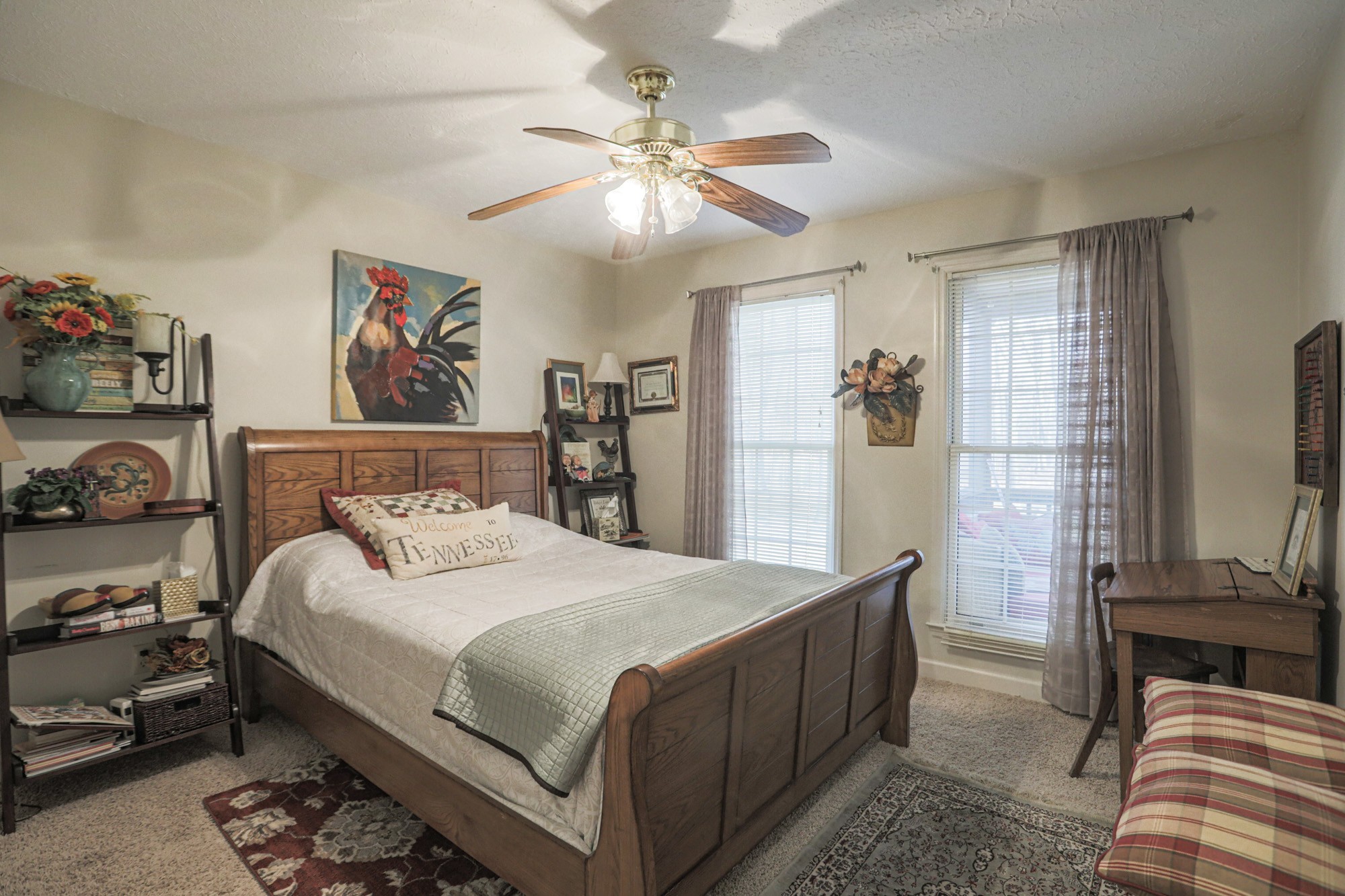 7126 Elrod Road Fairview, TN 37062 - Photo 21 of 36 a bedroom with a bed and a chandelier