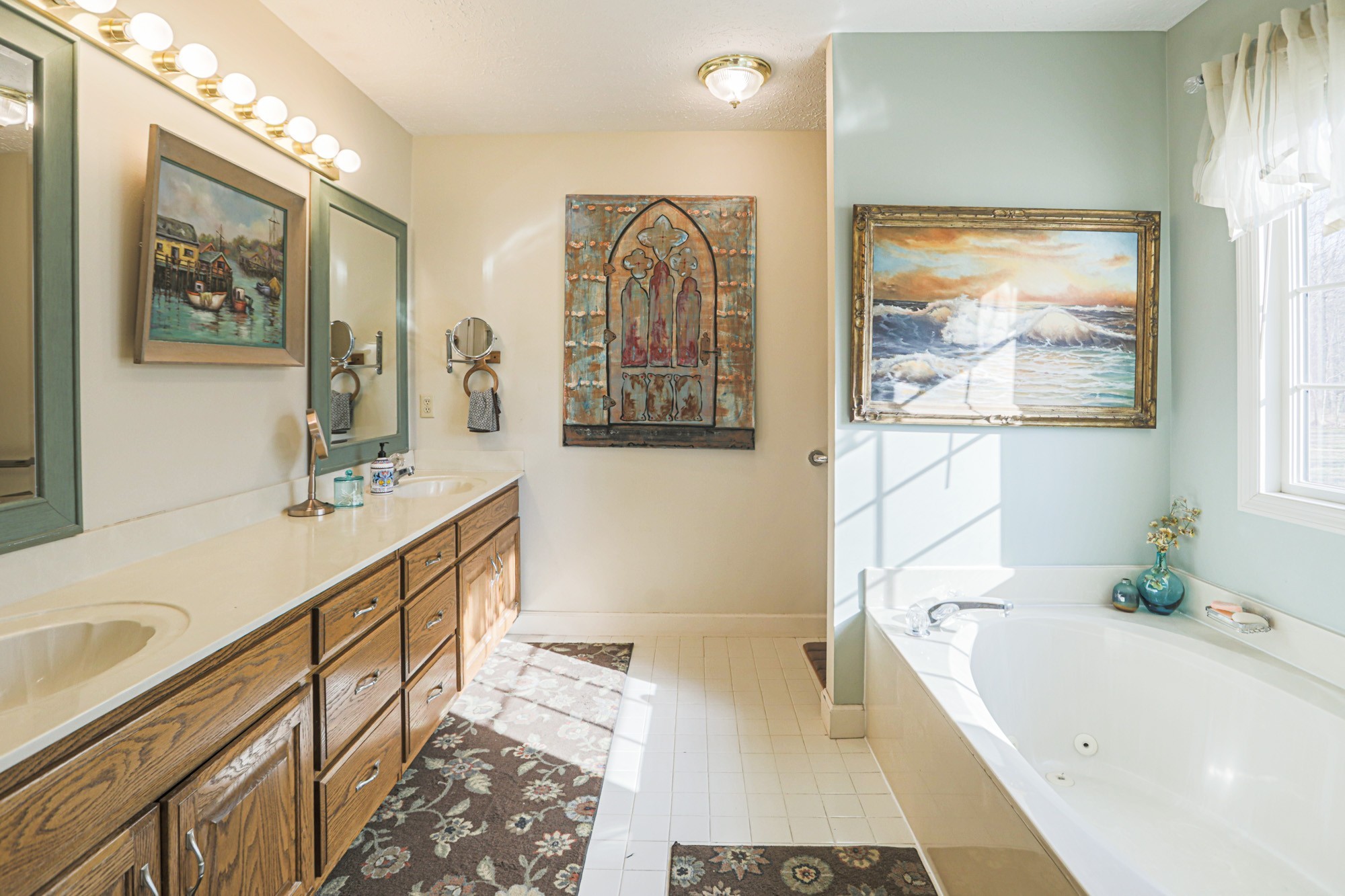 7126 Elrod Road Fairview, TN 37062 - Photo 24 of 36 a bathroom with a tub a sink and a large mirror