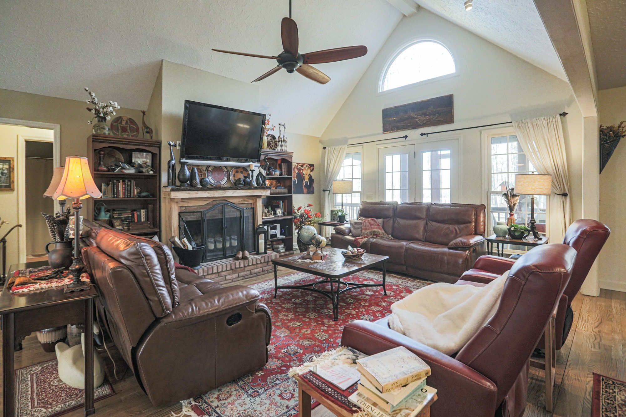 7126 Elrod Road Fairview, TN 37062 - Photo 28 of 36 a living room with furniture a flat screen tv and a fireplace