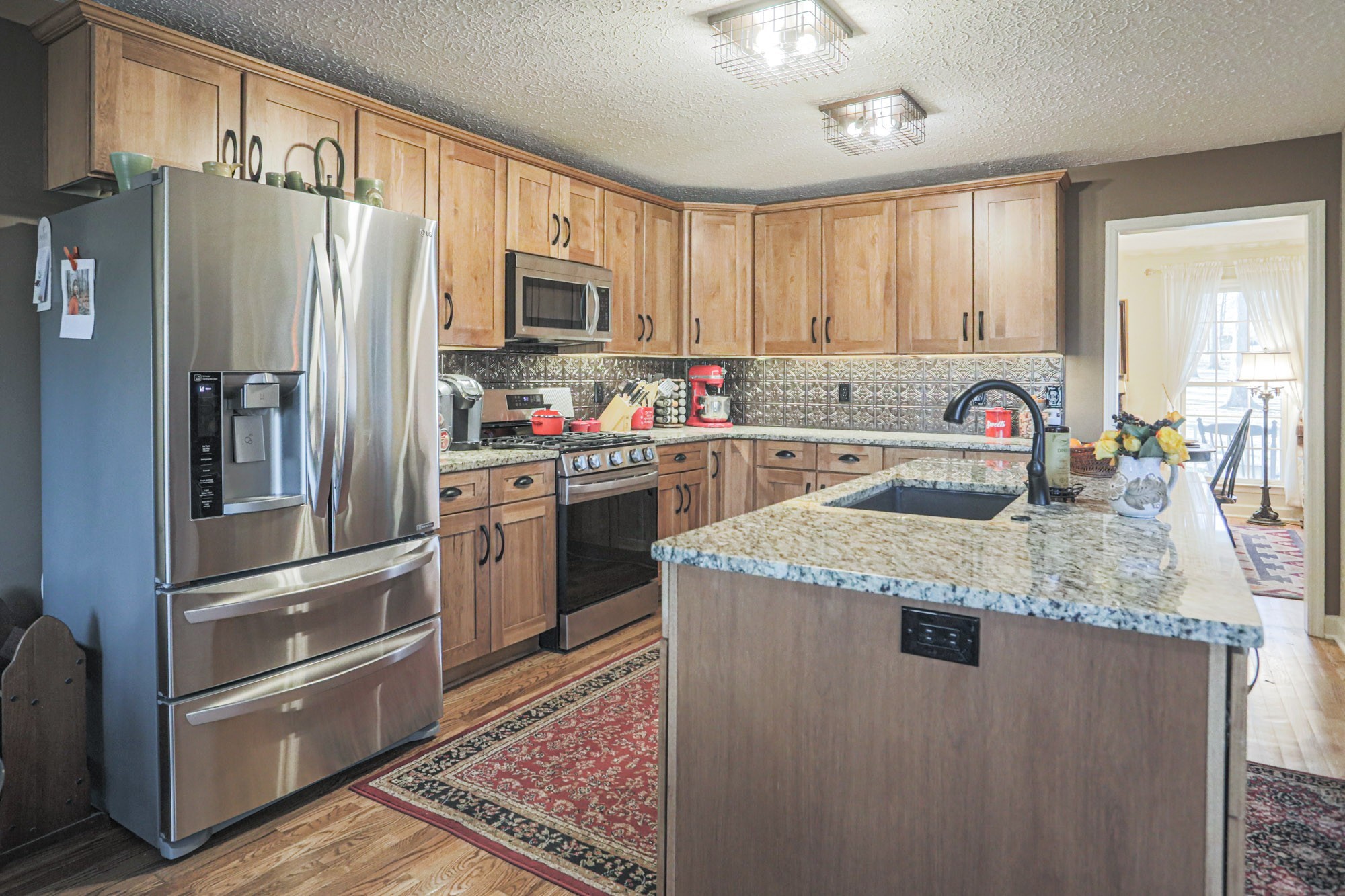 7126 Elrod Road Fairview, TN 37062 - Photo 30 of 36 a kitchen with stainless steel appliances granite countertop a refrigerator a stove a sink and dishwasher