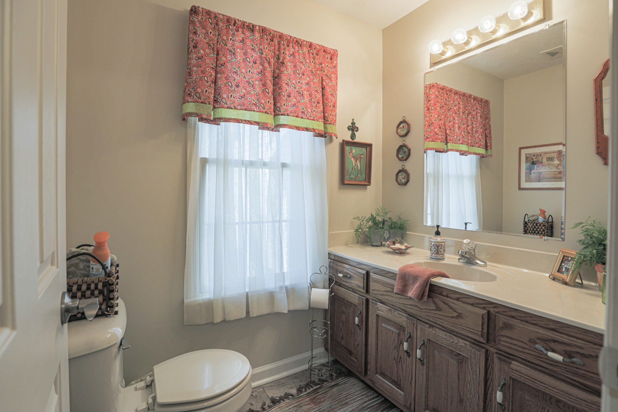 7126 Elrod Road Fairview, TN 37062 - Photo 32 of 36 a bathroom with a granite countertop sink mirror vanity and toilet