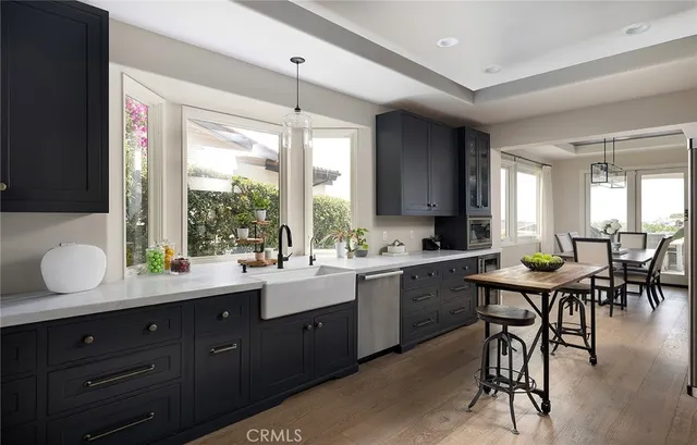 a dining room with furniture a chandelier and wooden floor