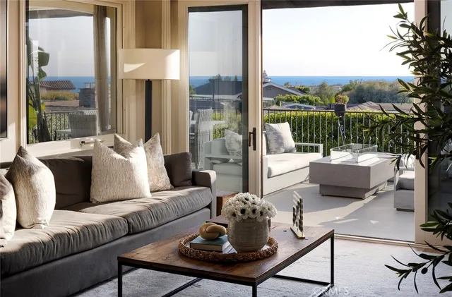 a living room with furniture and a floor to ceiling window