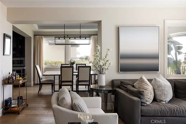 a living room with furniture a fireplace and a potted plant