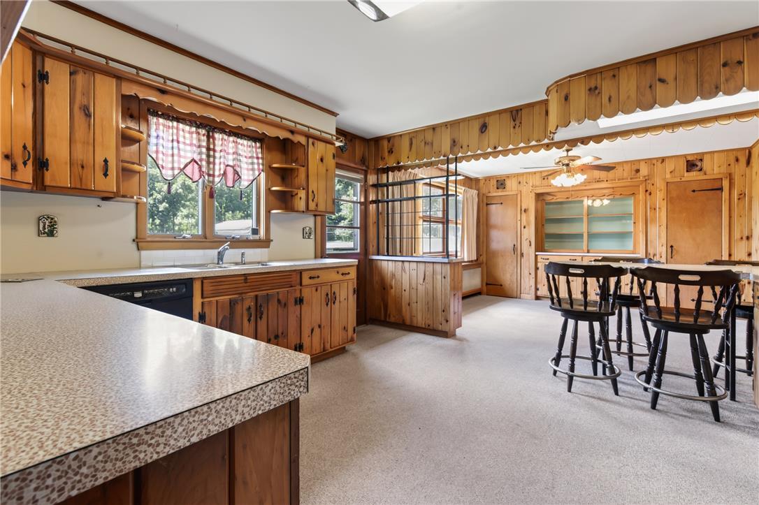 51 Reynolds Road Tamaqua, PA 18252 - Photo 20 of 71 A well-lit eat-in kitchen with warm wood paneling throughout.