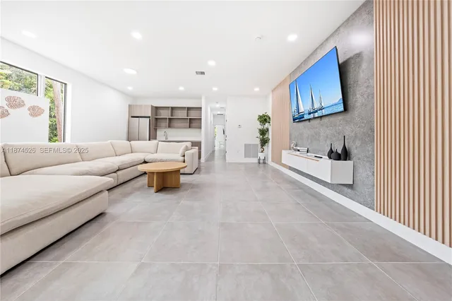 a modern kitchen with stainless steel appliances granite countertop a sink refrigerator and cabinets