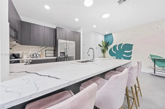 a bedroom with bed and paintings on the wall