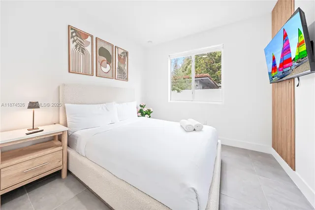 a spacious bedroom with a bed and a couch