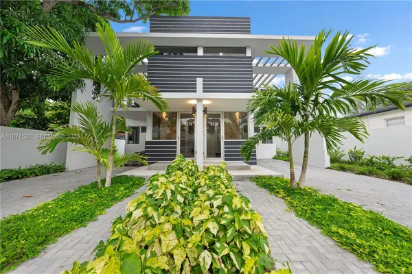 a front view of a house with garden