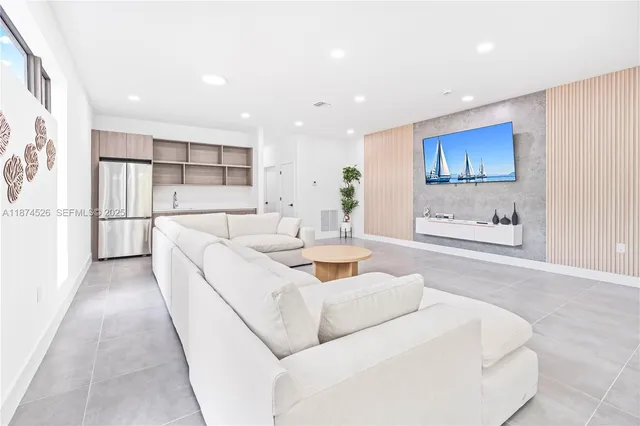a living room with furniture a large window and a flat screen tv