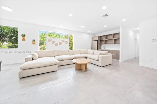 a living room with furniture and white walls