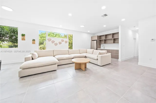 a living room with furniture and white walls