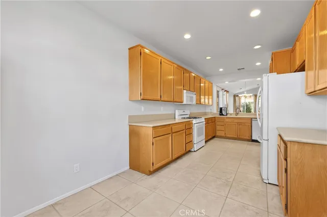 a large kitchen with a sink and cabinets