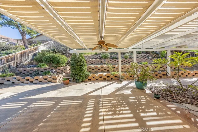 a view of a patio with table and chairs and potted plants