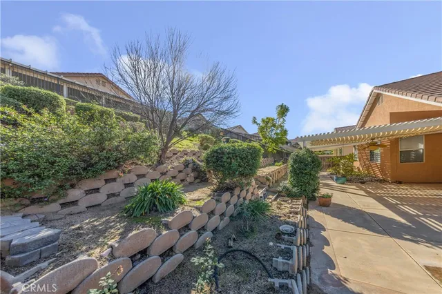 a view of a house with a yard and potted plants