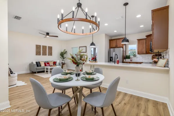 a view of a dining room with furniture window and wooden floor