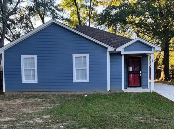 a brick house with a yard