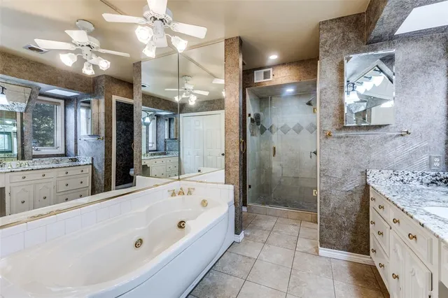a view of an empty room with a window and a ceiling fan