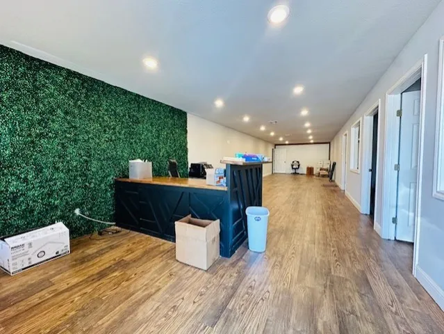 a view of kitchen and hall with wooden floor