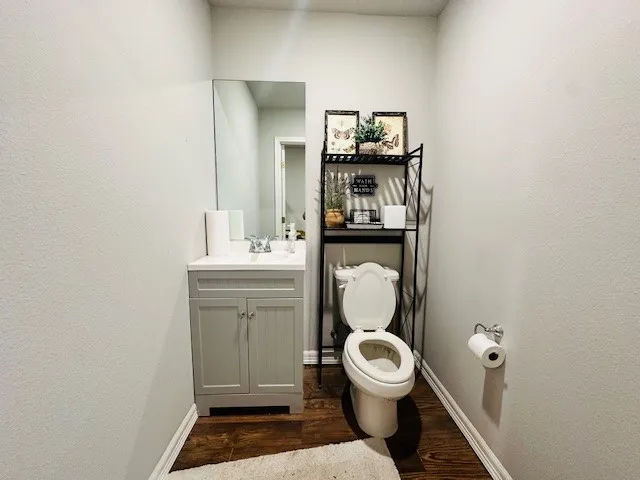 a bathroom with a toilet a sink and mirror