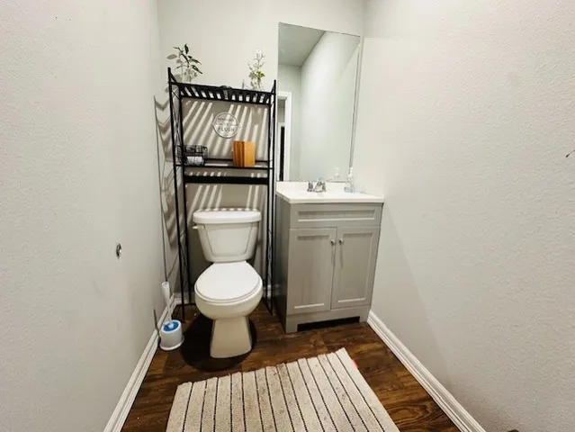 a bathroom with a toilet and a mirror
