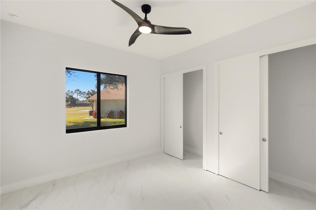 17 Long Meadow Road Rotonda West, FL 33947 - Photo 25 of 37 an empty room with windows and fan