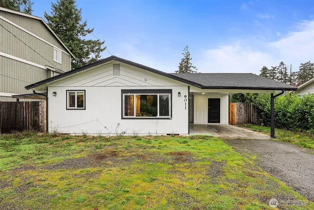 a front view of a house with a garden