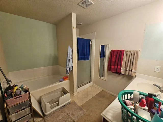 a bathroom with a tub sink and a mirror