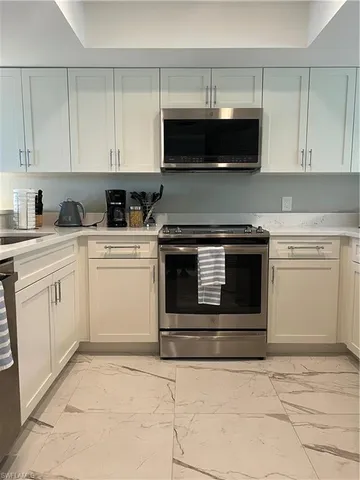 a kitchen with a sink and a refrigerator