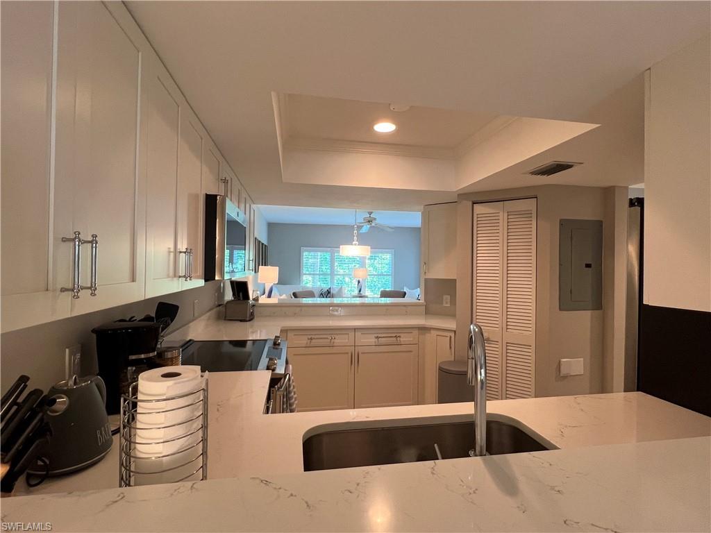5897 Chanteclair Drive, Unit 314A Naples, FL 34108 - Photo 12 of 21 a kitchen with a sink and a refrigerator