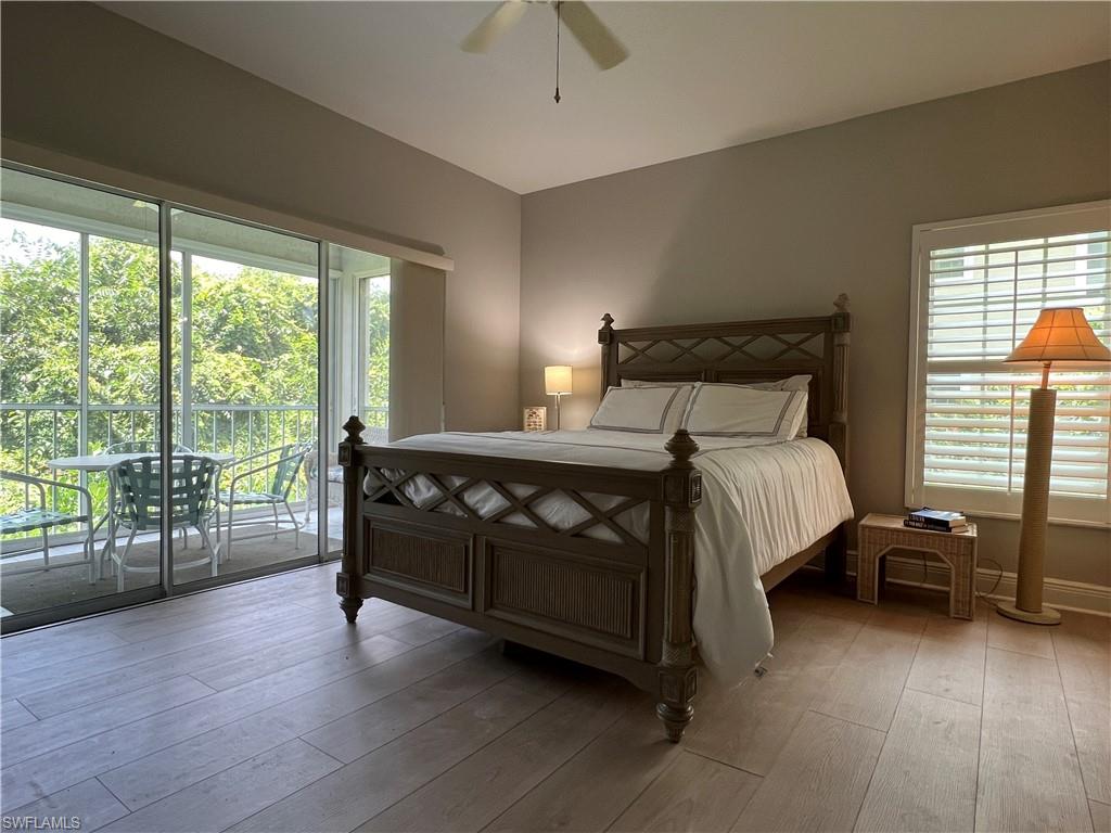 5897 Chanteclair Drive, Unit 314A Naples, FL 34108 - Photo 16 of 21 a bedroom with a bed and large windows