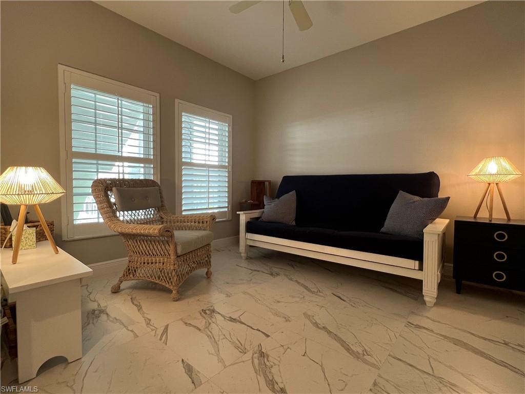 5897 Chanteclair Drive, Unit 314A Naples, FL 34108 - Photo 7 of 21 a living room with furniture and a lamp