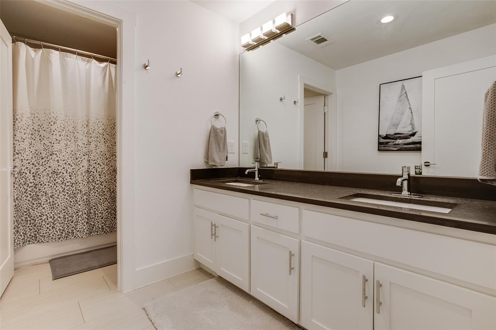 7141 Northaven Road Dallas, TX 75230 - Photo 27 of 38 a bathroom with a double vanity sink and a mirror
