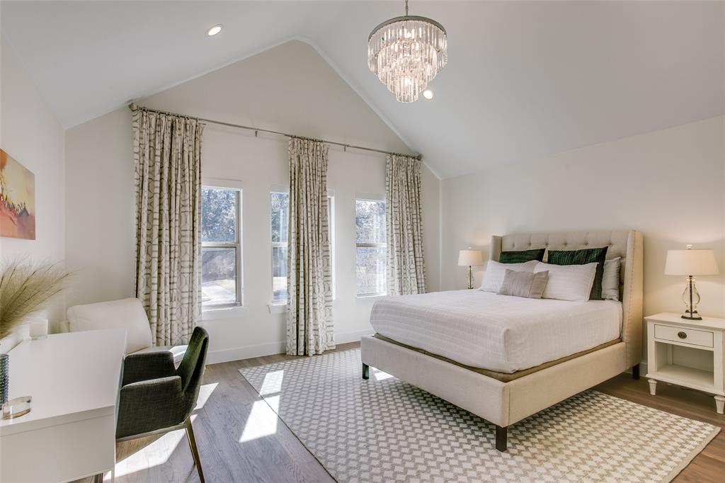 7141 Northaven Road Dallas, TX 75230 - Photo 32 of 38 a bedroom with a large bed and a chandelier