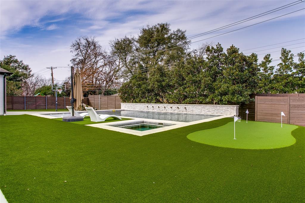 7141 Northaven Road Dallas, TX 75230 - Photo 37 of 38 a view of a swimming pool with a yard and trees