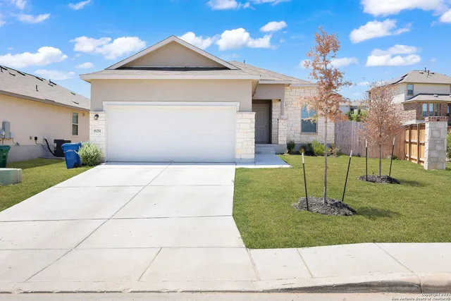 a front view of a house with a yard