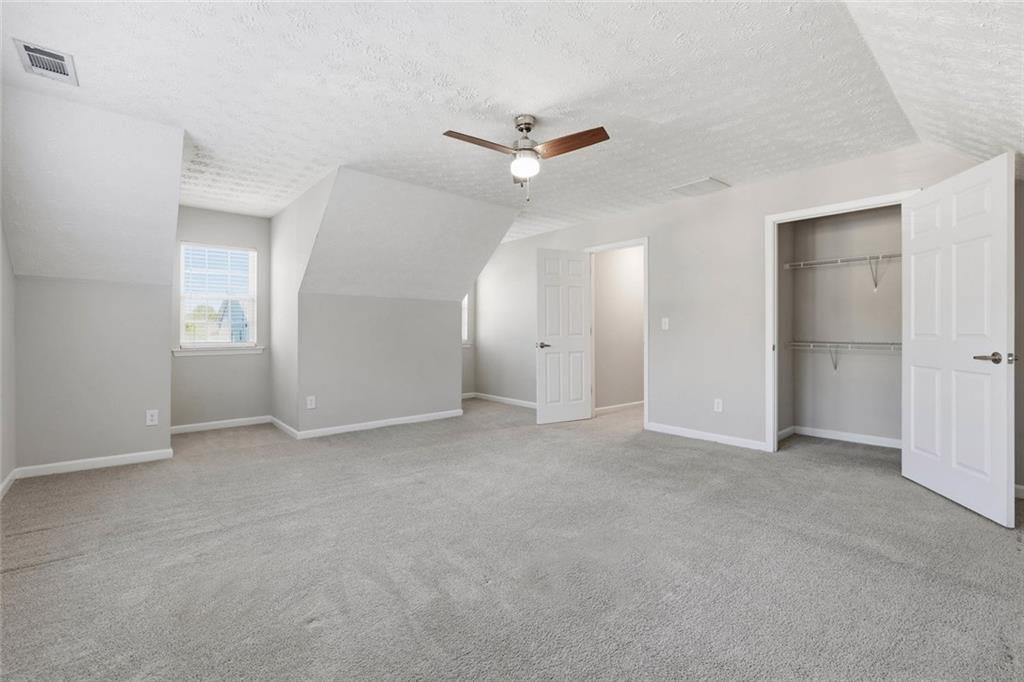 3570 Bogan Mill Road Northeast Buford, GA 30519 - Photo 26 of 31 an empty room with closet and windows