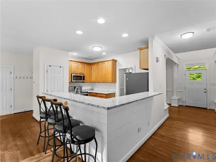 a kitchen with stainless steel appliances granite countertop a sink and a refrigerator
