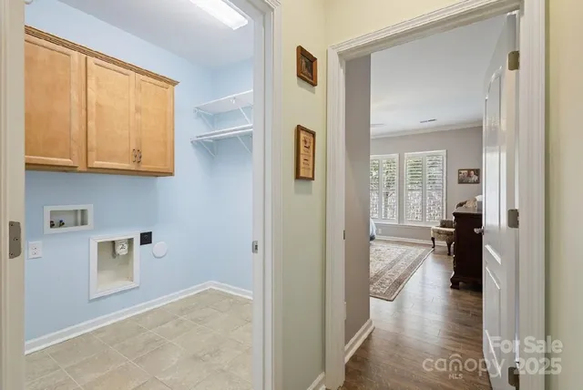 a view of a hallway with living room and dining room